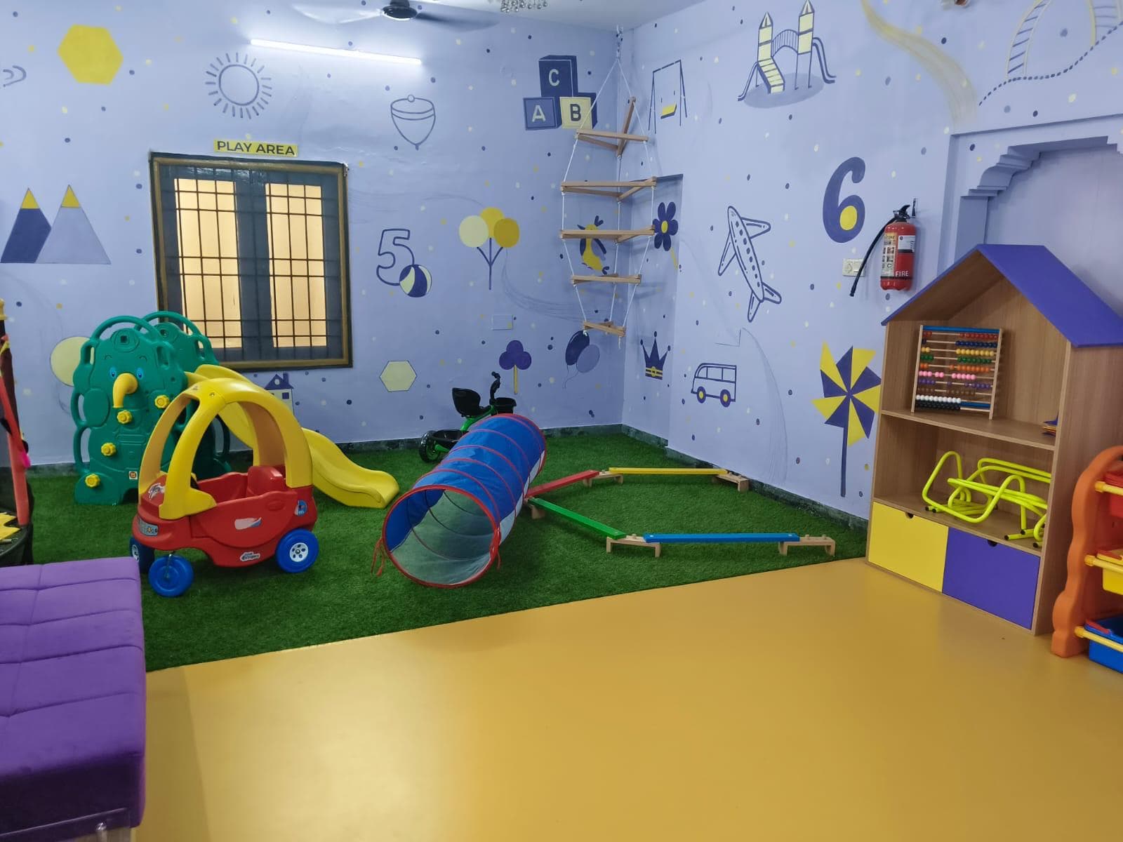 Indoor play area with ride-on car, slide and crawl tunnel