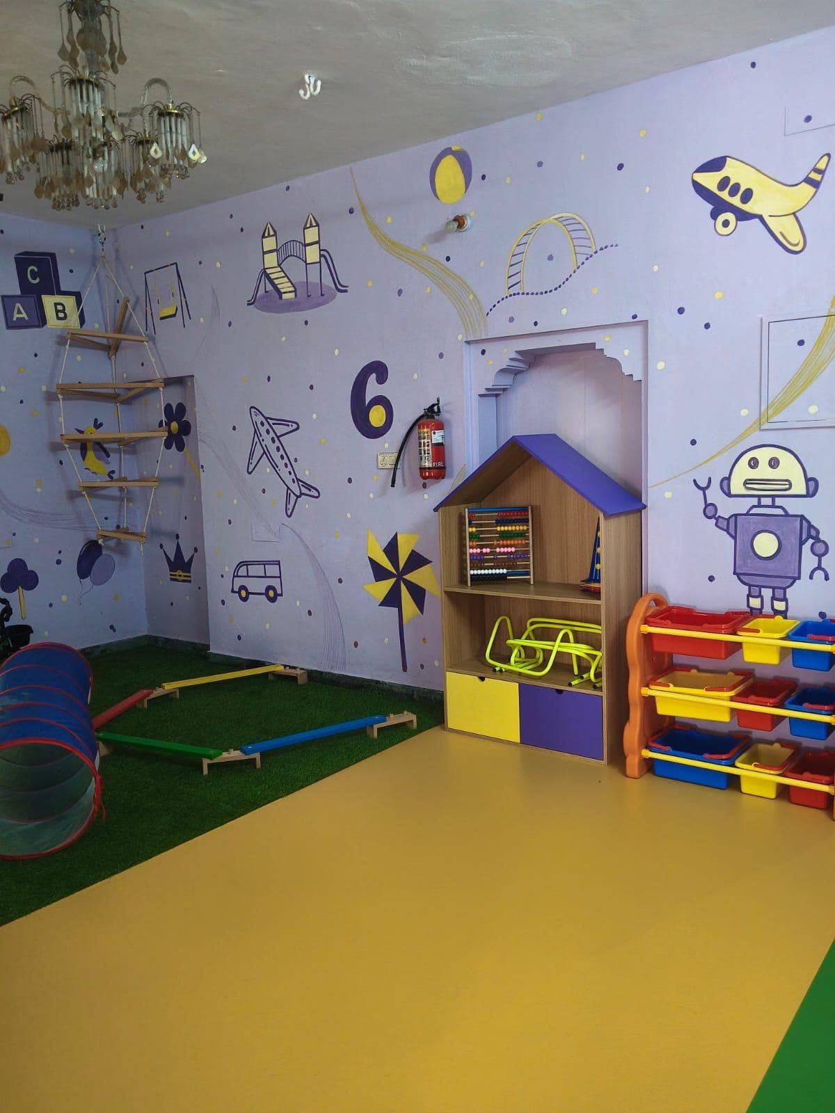 Play room with friendly robot mural, abacus and play house